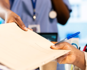 Medical professional giving a file to another