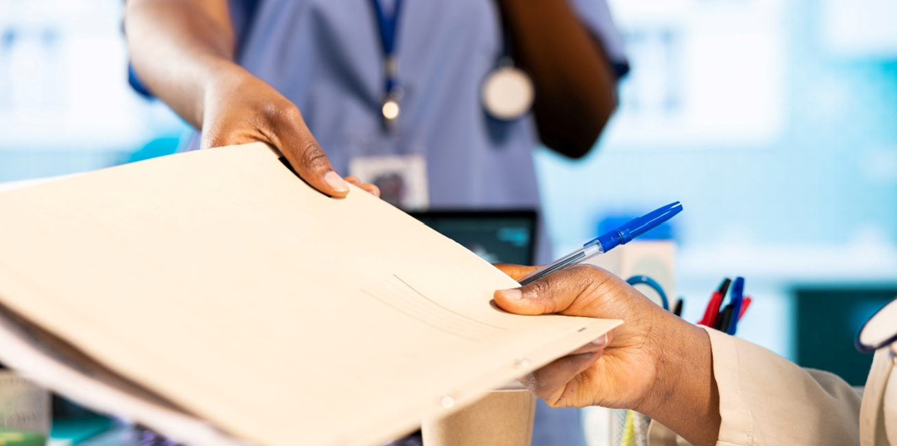 Medical professional giving a file to another