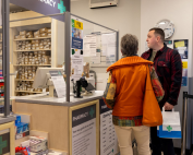 Two customers at a pharmacy counter