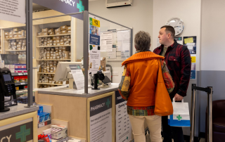 Two customers at a pharmacy counter